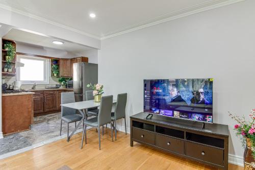 a kitchen and dining room with a large flat screen tv at Beautiful house near bluffers beach, 25 minutes to Toronto Downtown, free parking, and wifi in Toronto