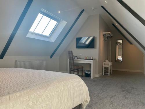 a bedroom with a bed and a desk with a window at Wellington house in Blythe
