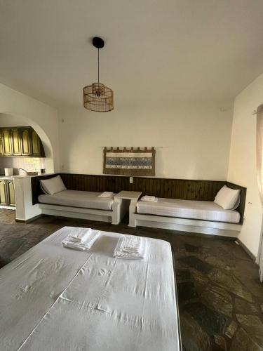 a living room with two white couches and a table at Casa Paros in Parikia