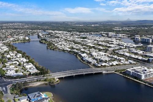 an aerial view of a city with a bridge over a river at Luxury Living with Heated Pool in Birtinya in Kawana Waters