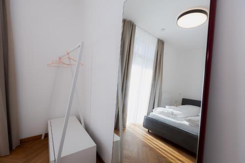 a mirror in a room with a bed and a bed sqor at Alpine Apartements Maximilian in Berchtesgaden