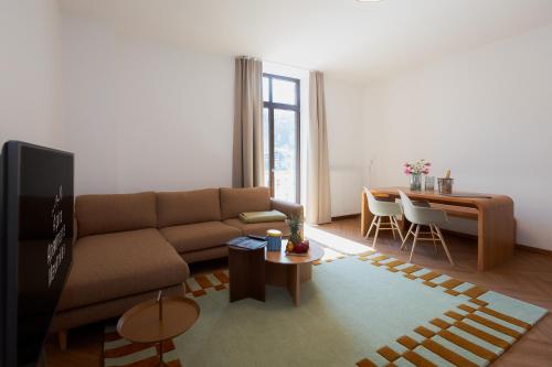 a living room with a couch and a table at Alpine Apartements Maximilian in Berchtesgaden