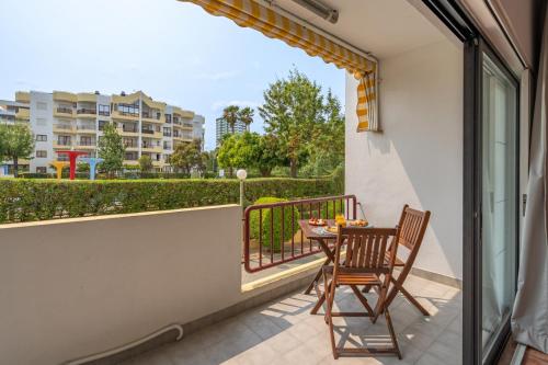 a balcony with a table and two chairs on it at HostWise - Sunny Flat Near Praia da Rocha in Portimão