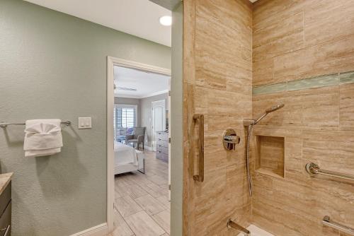a bathroom with a walk in shower next to a toilet at Crescent Royale Condominiums 501 in Siesta Key