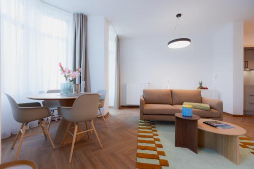 a living room with a couch and a table at Alpine Apartements Maximilian in Berchtesgaden