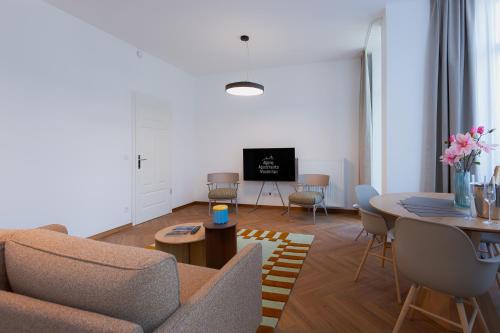 a living room with a couch and a table at Alpine Apartements Maximilian in Berchtesgaden