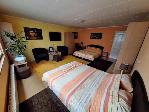 a bedroom with two beds and a potted plant at Modern&Cozy Bosnian house with GARDEN+FREE parking in Sarajevo