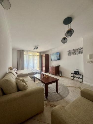 a living room with a couch and a table at Marena Studio - Santa Marina, Sozopol in Sozopol