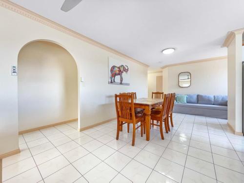 a dining room with a table and chairs and a couch at 2BRM Self Contained Apt - Pumicestone Passage View in Bellara