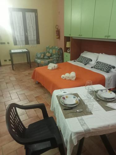 a room with two beds and a table and a chair at Casa del dottore in Cefalù