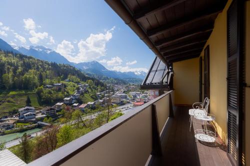 a balcony with a view of a town and mountains at Alpine Apartements Maximilian in Berchtesgaden
