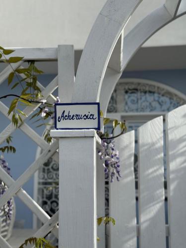 a sign on a pole with a building in the background at Pharus Miseni Suites and rooms in Bacoli