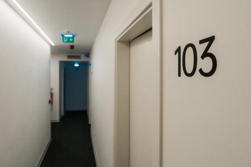 a hallway in a hospital with a number on the wall at Casa do Parque Nature & Heritage Hotel in Castelo de Vide
