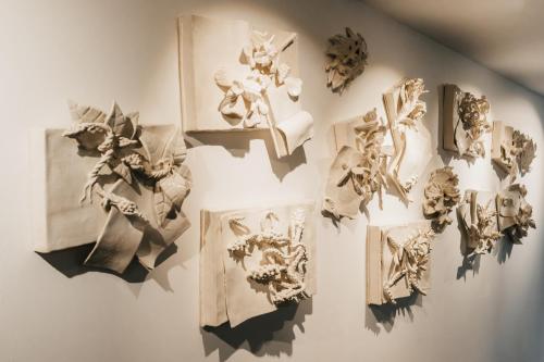 a white wall with pictures on it at Casa do Parque Nature & Heritage Hotel in Castelo de Vide