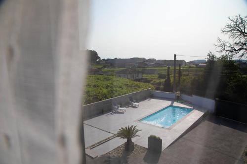 a view of a swimming pool from a building at GALIHOST - Villa Gandara in Ribadumia