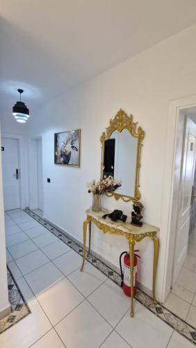 a dressing table with a mirror on a white wall at Frekel Hotel in Tirana