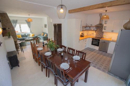 a kitchen and dining room with a table and chairs at Casa Jana 5 Bedroom House for 12 with Ocean View Terrace near the Beach in Burgau