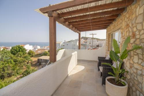 a balcony of a house with a view of the ocean at Casa Jana 5 Bedroom House for 12 with Ocean View Terrace near the Beach in Burgau