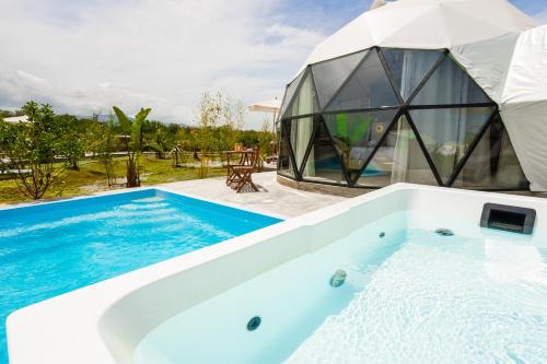 a villa with a pool and a glass house at Emerald Oasis By Azul Collection in Pigianos Kampos