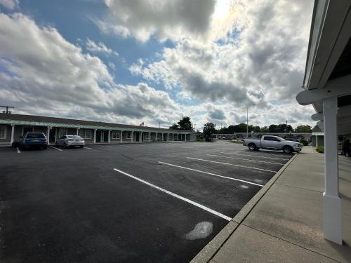 a parking lot with cars parked in front of a building at Sea Girt Lodge in Sea Girt