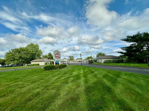 a street with a field of grass next to a road at Sea Girt Lodge in Sea Girt