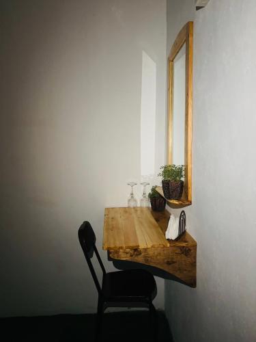 a table with a chair and a mirror on a wall at Jaya Residence - Near Airport in Negombo