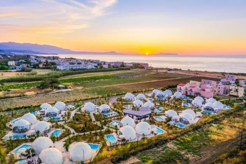 an aerial view of a resort on the beach at sunset at Emerald Oasis By Azul Collection in Pigianos Kampos