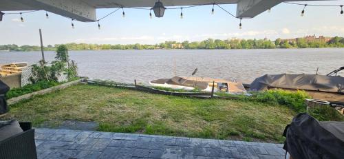 a couple of boats are docked on the water at Lovely loft on the water, with free parking in Laval