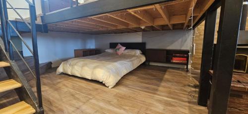 a bedroom with a large bed in a loft at Lovely loft on the water, with free parking in Laval