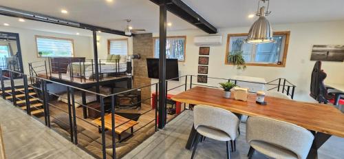 a living room with a table and chairs and a kitchen at Lovely loft on the water, with free parking in Laval