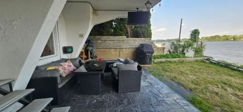 a living room with couches and a view of the water at Lovely loft on the water, with free parking in Laval