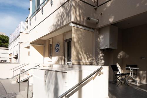 a white building with a balcony with a table at La Maison de Monet in Brindisi