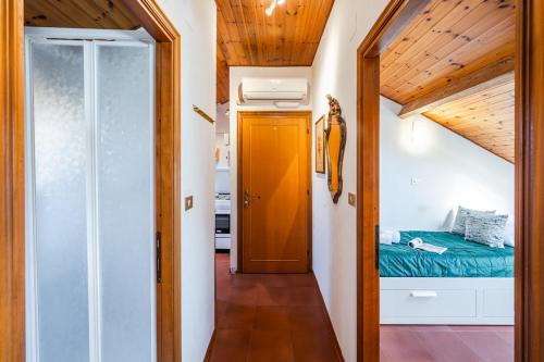 a small room with a bed and a hallway at Cozy Rooftop Flat - Steps from the sea - AC and WiFi in Santa Margherita Ligure