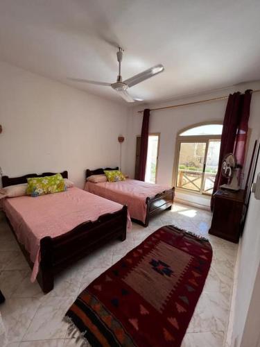 a bedroom with two beds and a window at villa at blue lagoon resort rassudr for families only in Ras Sedr