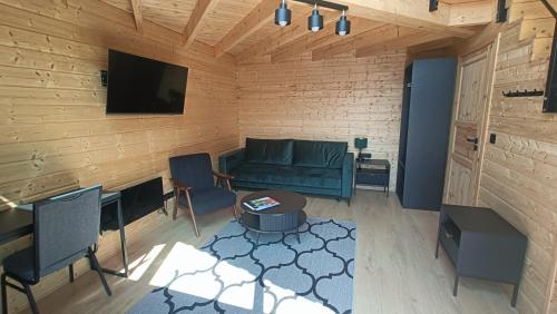 a living room with a couch and a table at Hotel Węgierki in Września