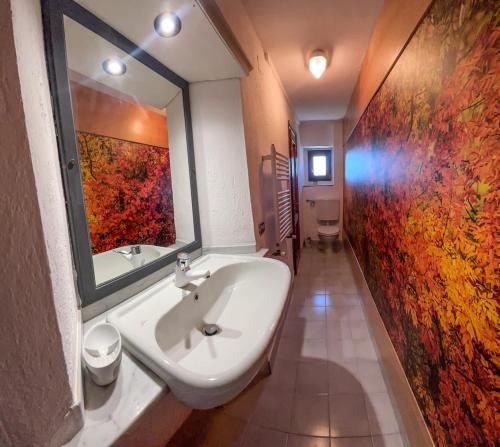 a bathroom with a sink and a large mirror at Locanda degli Dei in SantʼAgata