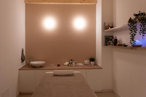 a bathroom with a sink and a counter at ALOE Comfort Rooms in Pescara
