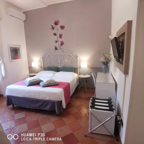 Ένα ή περισσότερα κρεβάτια σε δωμάτιο στο B&B La Magnolia