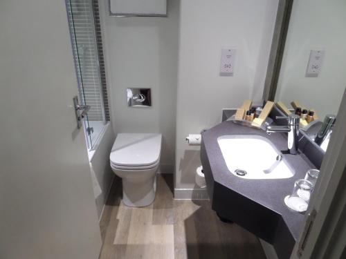 a bathroom with a sink and a toilet at Holiday Inn Birmingham M6, Jct7 by IHG in Birmingham