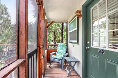 a porch with a chair and a door at Tiny House on the Hill in New Braunfels