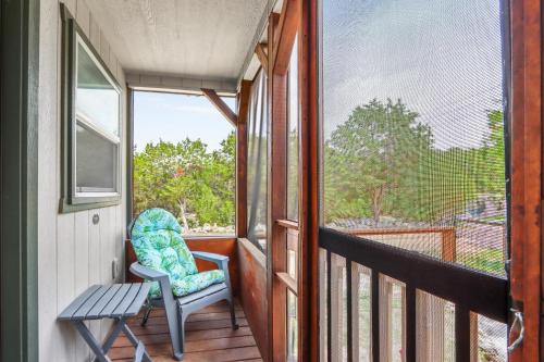 a porch with a chair and a bench and a window at Tiny House on the Hill in New Braunfels