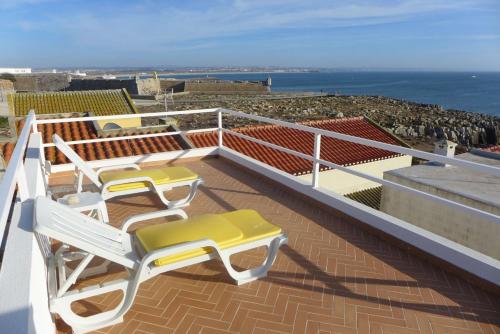 a balcony with chairs and a view of the ocean at Casa do Gato que queria ser Pescador in Peniche