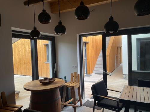 a room with a table and chairs and a glass door at Chatka za vodou in Trutnov