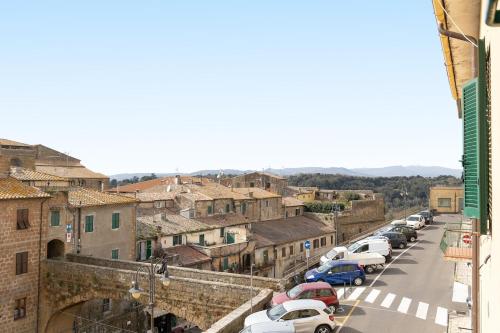a row of cars parked on a city street at La Dimora del Borgo - Panoramic View in Pitigliano