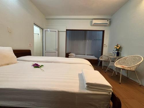Una cama o camas en una habitación de Chân Mây Tam Đảo
