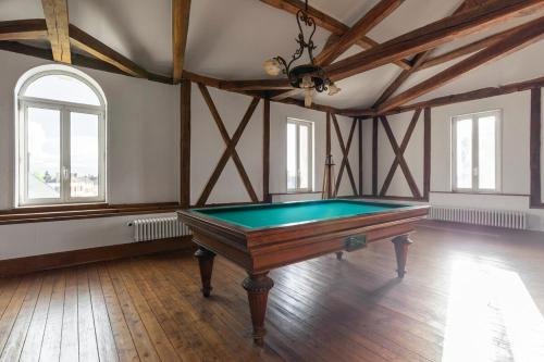 une grande pièce avec une table de billard à l'intérieur dans l'établissement Domaine des Étoiles du Gâtinais, 