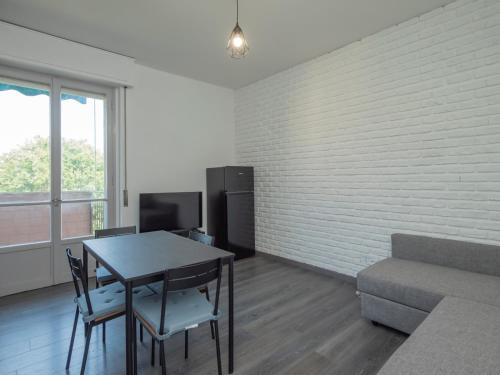 a living room with a table and a couch at I-Host Apartment - Omero 17 in Milan