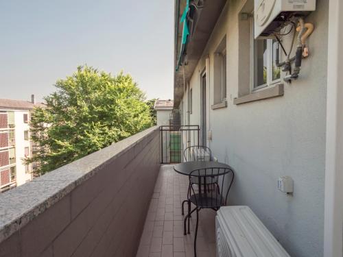 a patio with two chairs and a table on a balcony at I-Host Apartment - Omero 17 in Milan