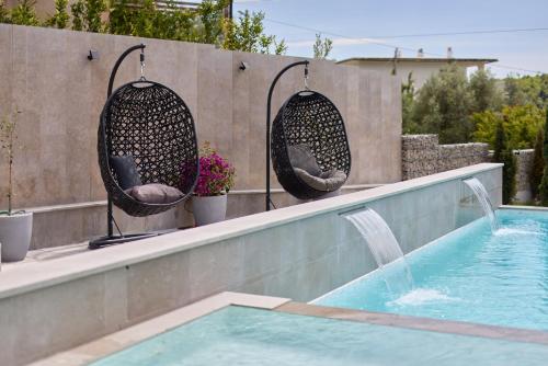 a swimming pool with two chairs next to a swimming pool at Villa Oaza with Outdoor Pool in Kotor