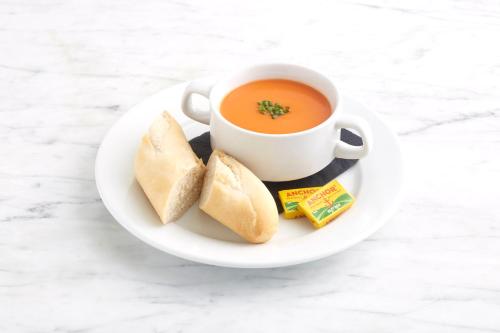 a cup of soup and some biscuits on a plate at Holiday Inn Brighton Seafront by IHG in Brighton & Hove